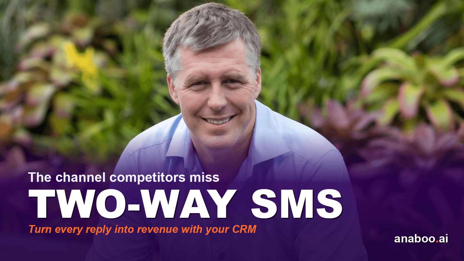 Business professional checking SMS replies on a smartphone beside a CRM dashboard showing live conversation threads and conversion metrics
